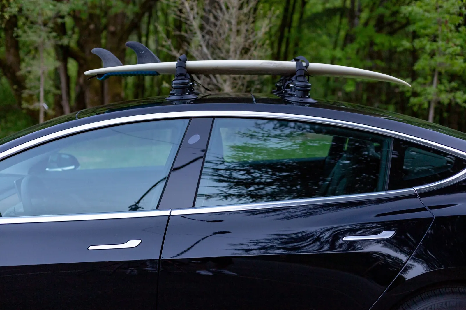 Surfboard on a STAG Rack on a black sedan with no roof rails