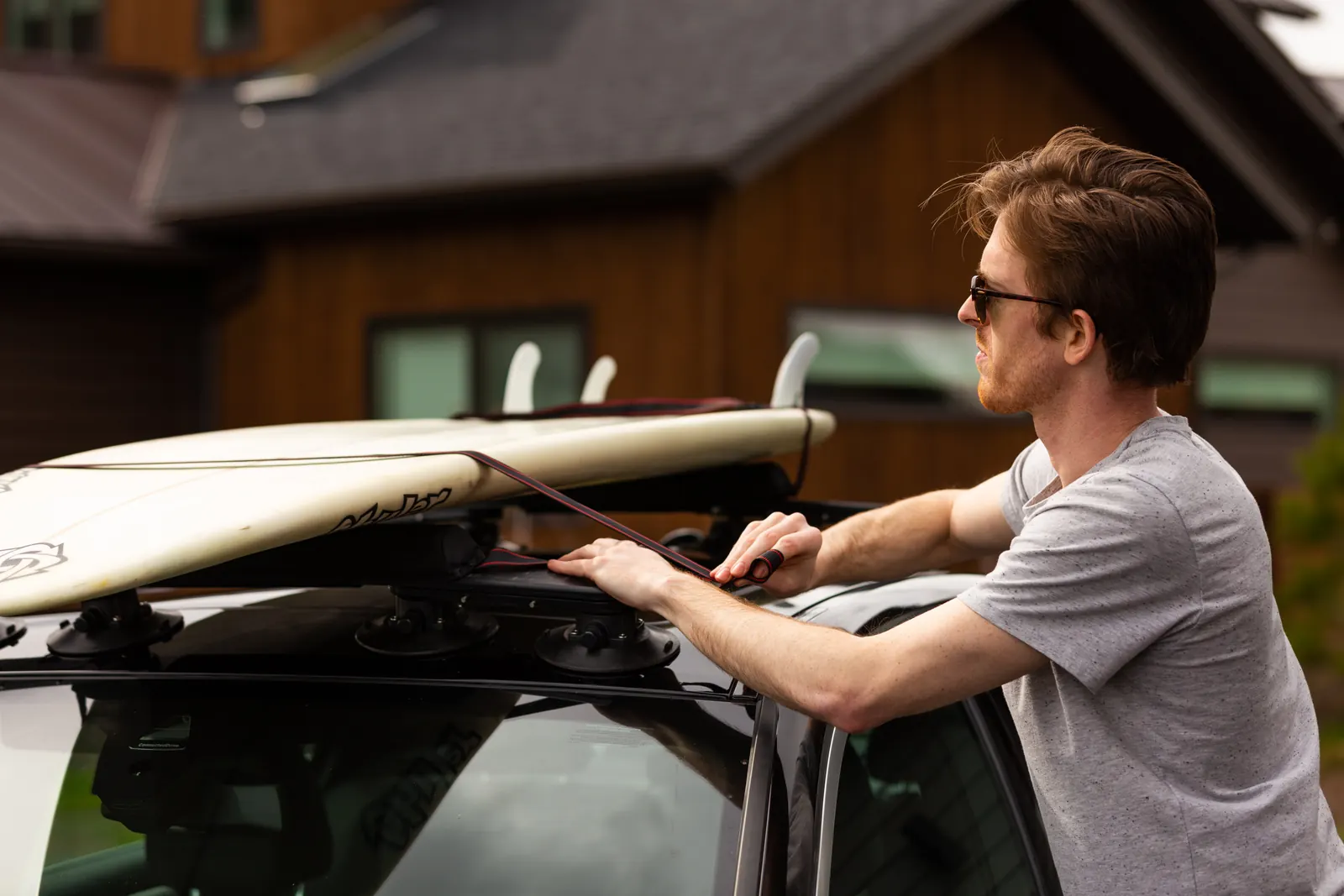 Strapping a surfboard to the STAG surf rack